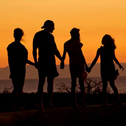 Family of four holding hands outdoors