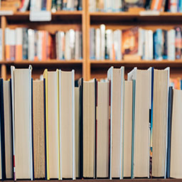 Multiple book shelves with different types of books